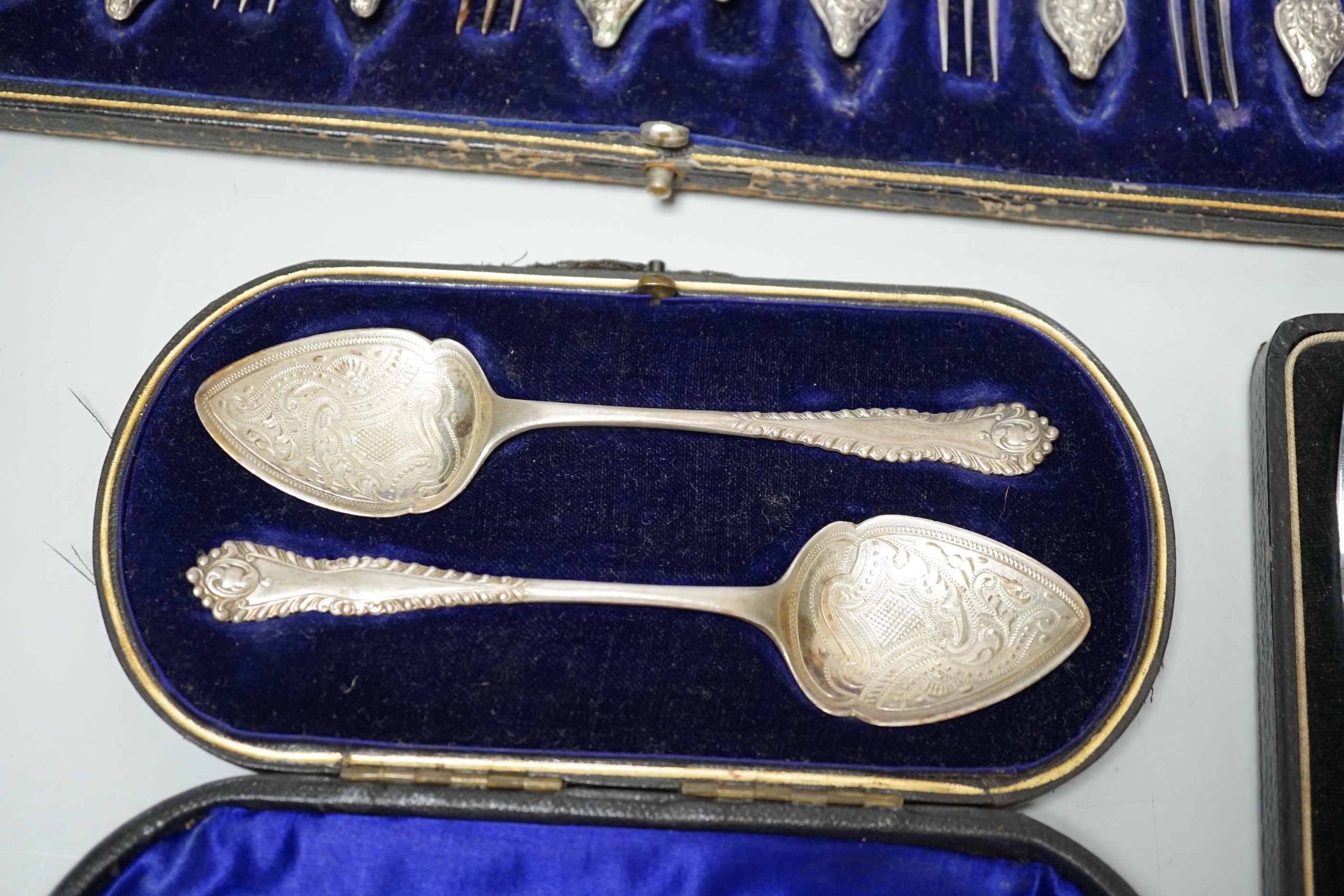 Two cased sets of silver flatware including teaspoons and pair of small servers and two cased sets of plated flatware.